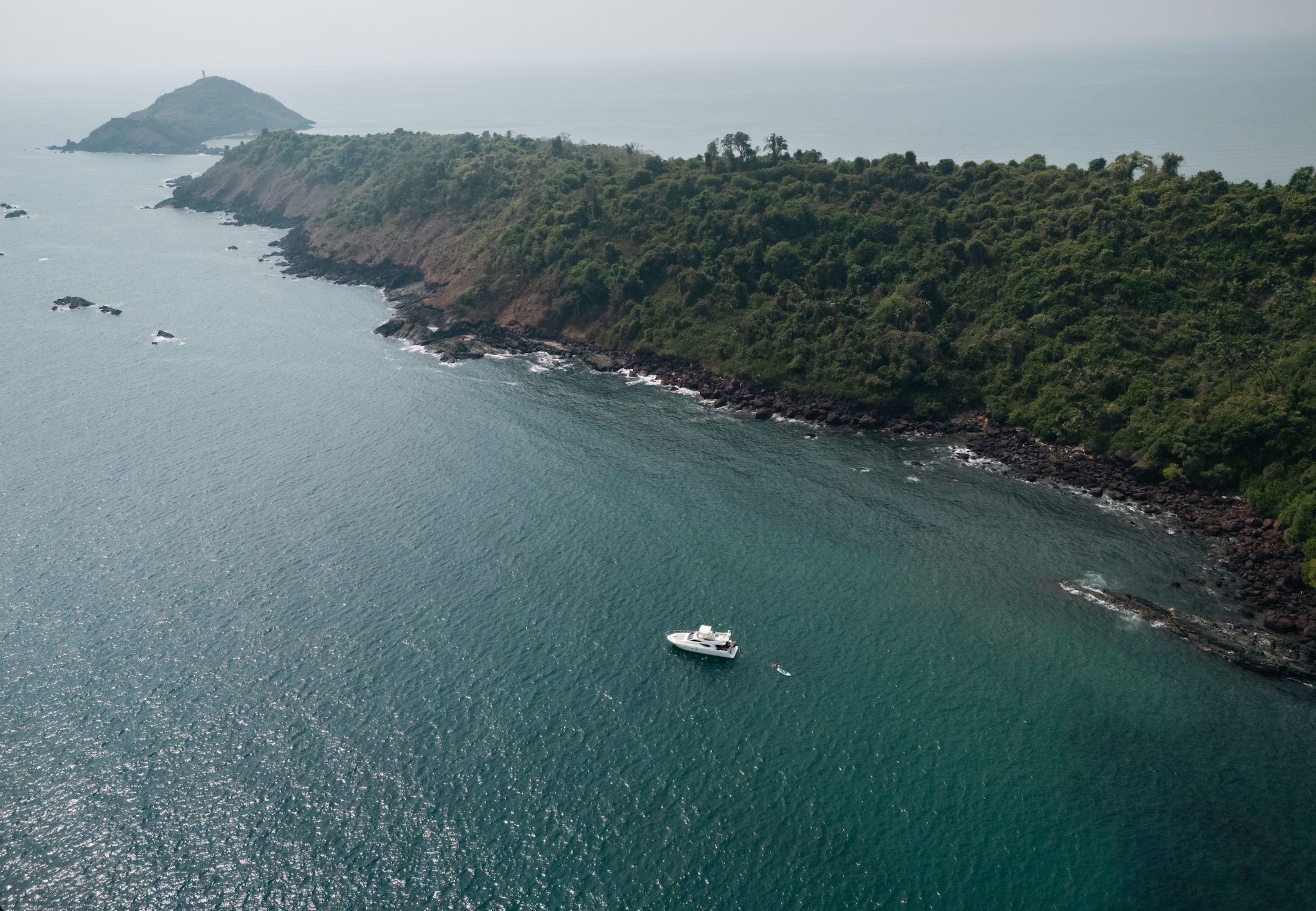 the yacht at anchor off a secluded beach